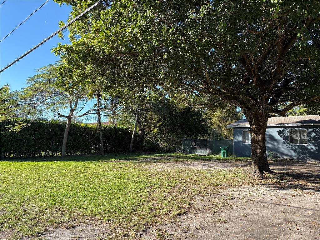 45 Northeast 146th Street, Unit B Miami, FL 33161 - Photo 2 of 16 a view of swimming pool with a bench and trees