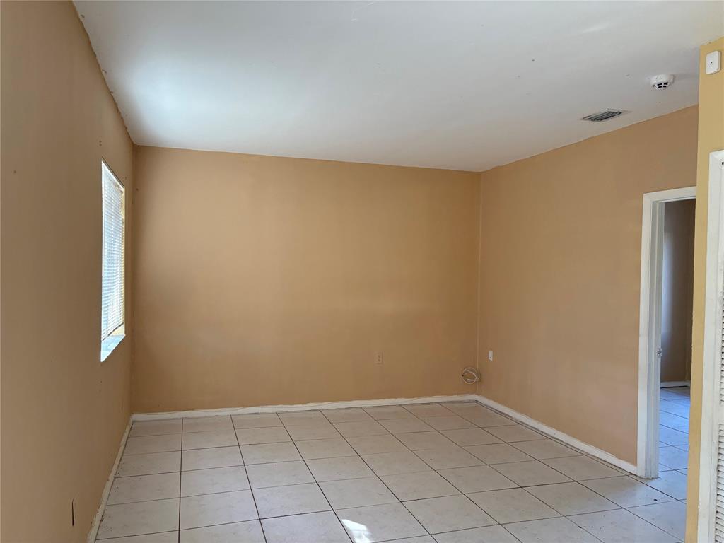 45 Northeast 146th Street, Unit B Miami, FL 33161 - Photo 6 of 16 an empty room with a empty space and windows