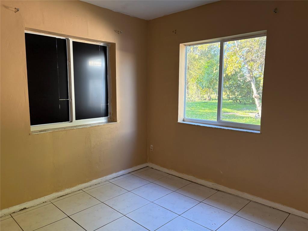 45 Northeast 146th Street, Unit B Miami, FL 33161 - Photo 7 of 16 a view of an empty room with window and closet area