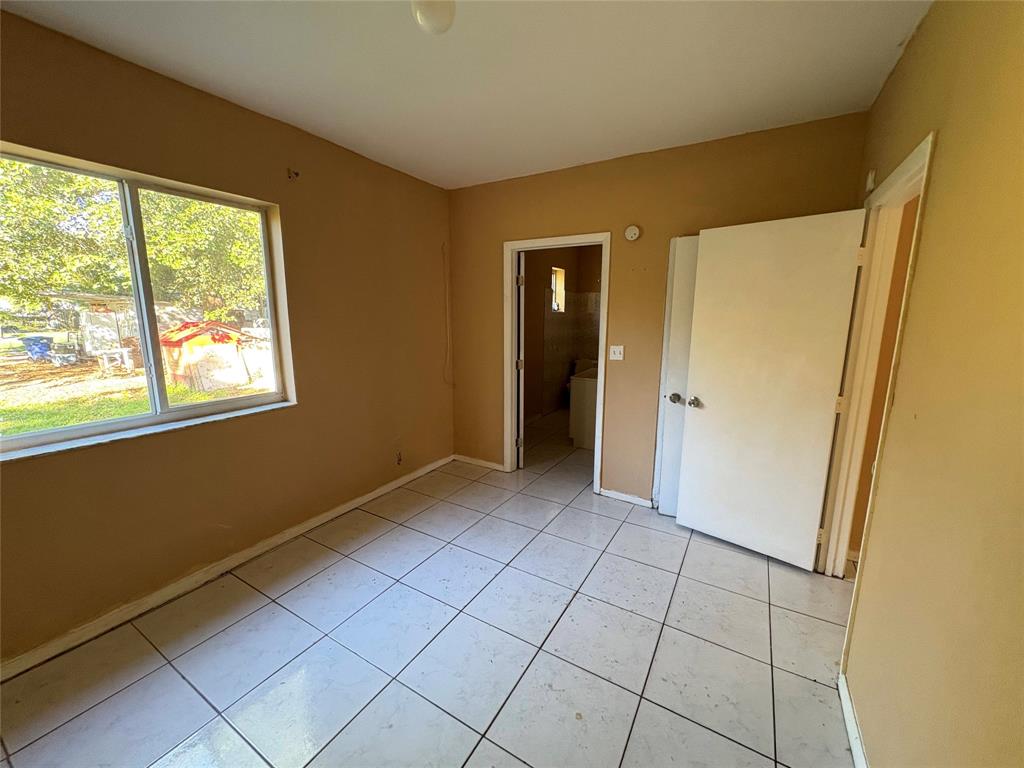 45 Northeast 146th Street, Unit B Miami, FL 33161 - Photo 8 of 16 a view of an empty room with window and refrigerator