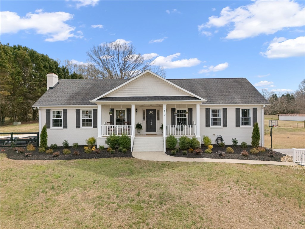 200 Poore Road Piedmont, SC 29673 - Photo 1 of 44 This charming home offers a welcoming facade with a covered porch, perfect for outdoor relaxation.