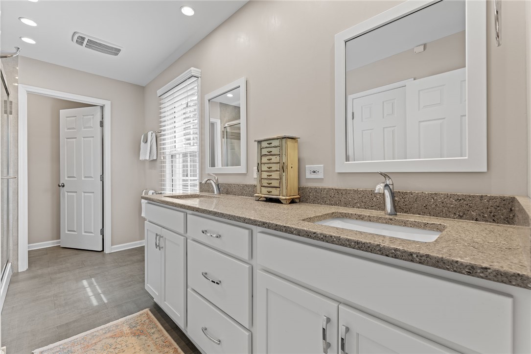 200 Poore Road Piedmont, SC 29673 - Photo 21 of 44 This spacious bathroom offers dual vanities with ample counter space for daily routines.
