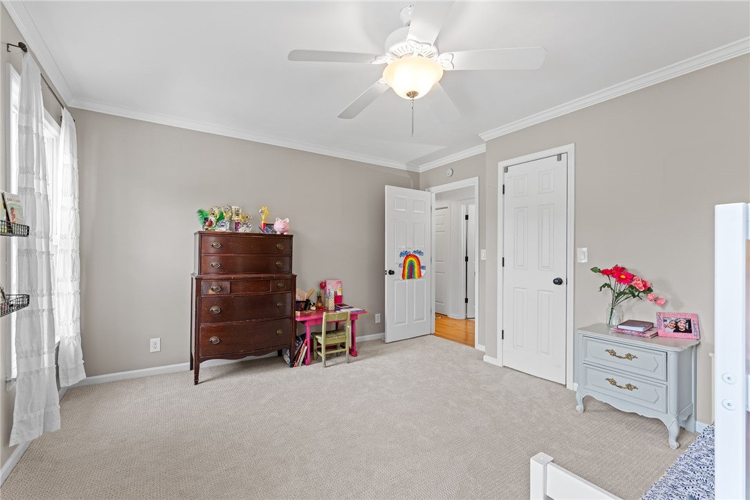 200 Poore Road Piedmont, SC 29673 - Photo 24 of 44 This spacious bedroom offers comfortable carpeting and elegant crown molding, creating a serene personal retreat.