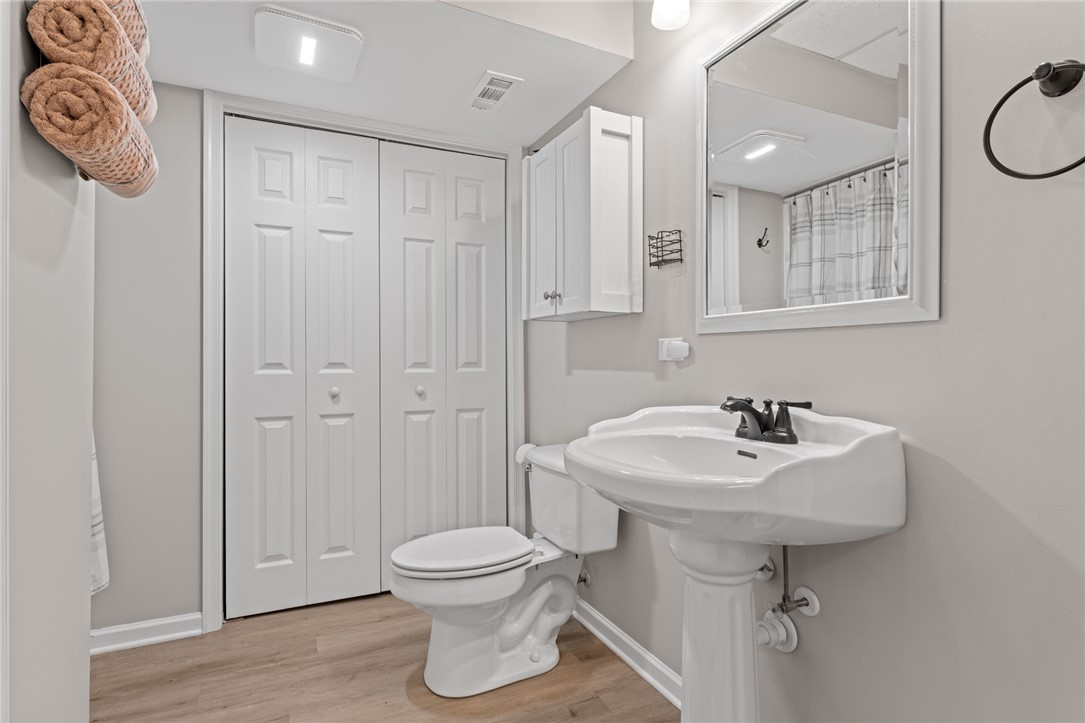 200 Poore Road Piedmont, SC 29673 - Photo 34 of 44 This updated bathroom features a sleek pedestal sink and convenient storage solutions.