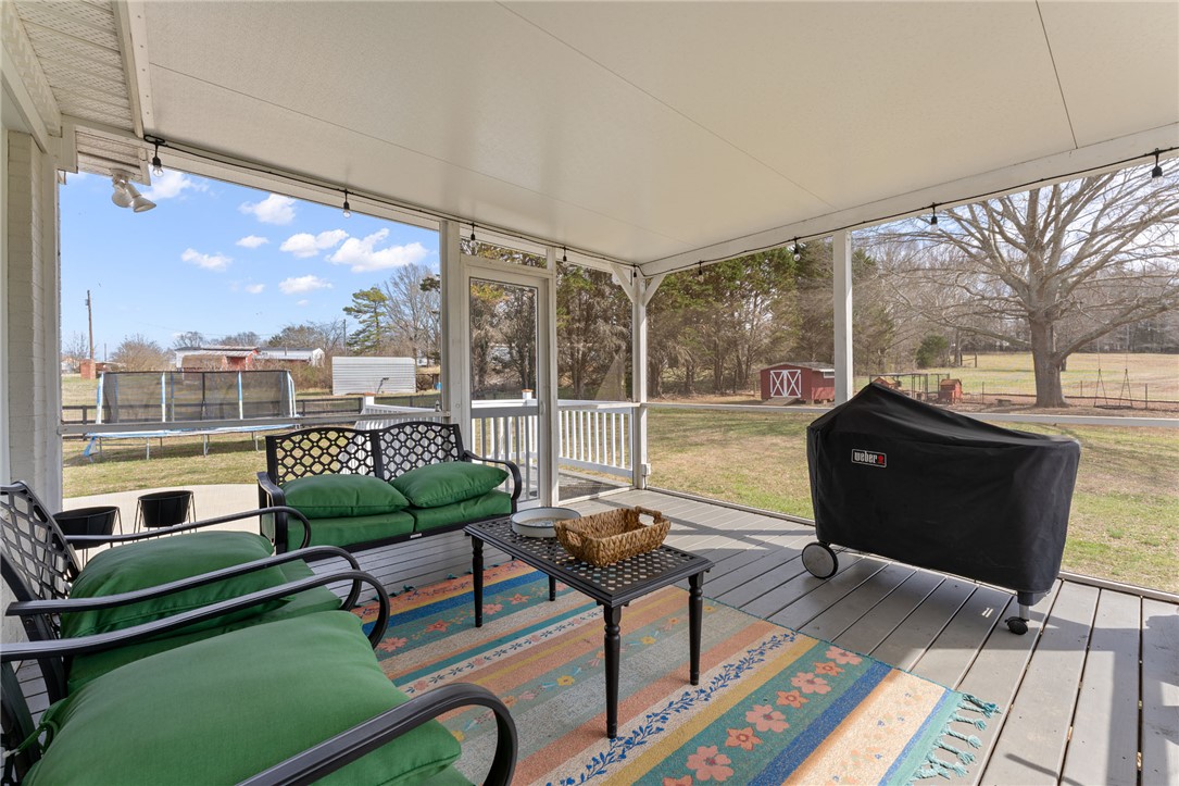 200 Poore Road Piedmont, SC 29673 - Photo 36 of 44 Relax and unwind in this inviting screened-in porch, offering tranquil views of the expansive yard.