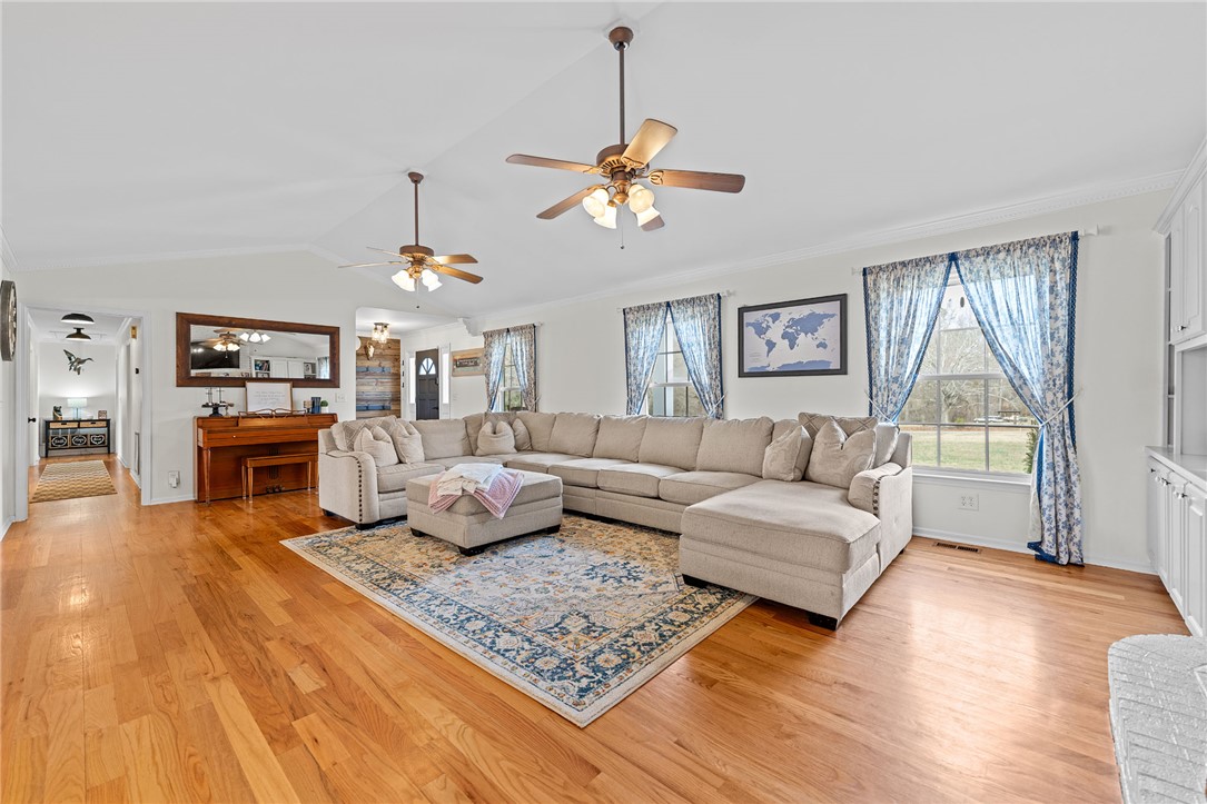 200 Poore Road Piedmont, SC 29673 - Photo 6 of 44 This bright living room features hardwood floors and vaulted ceilings, perfect for relaxed gatherings.