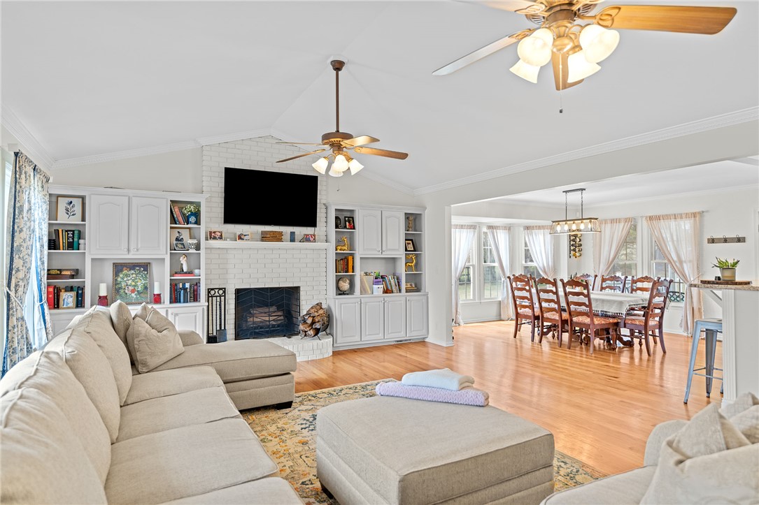 200 Poore Road Piedmont, SC 29673 - Photo 8 of 44 This bright living space features an inviting fireplace and built-in shelving, seamlessly flowing into the dining area.