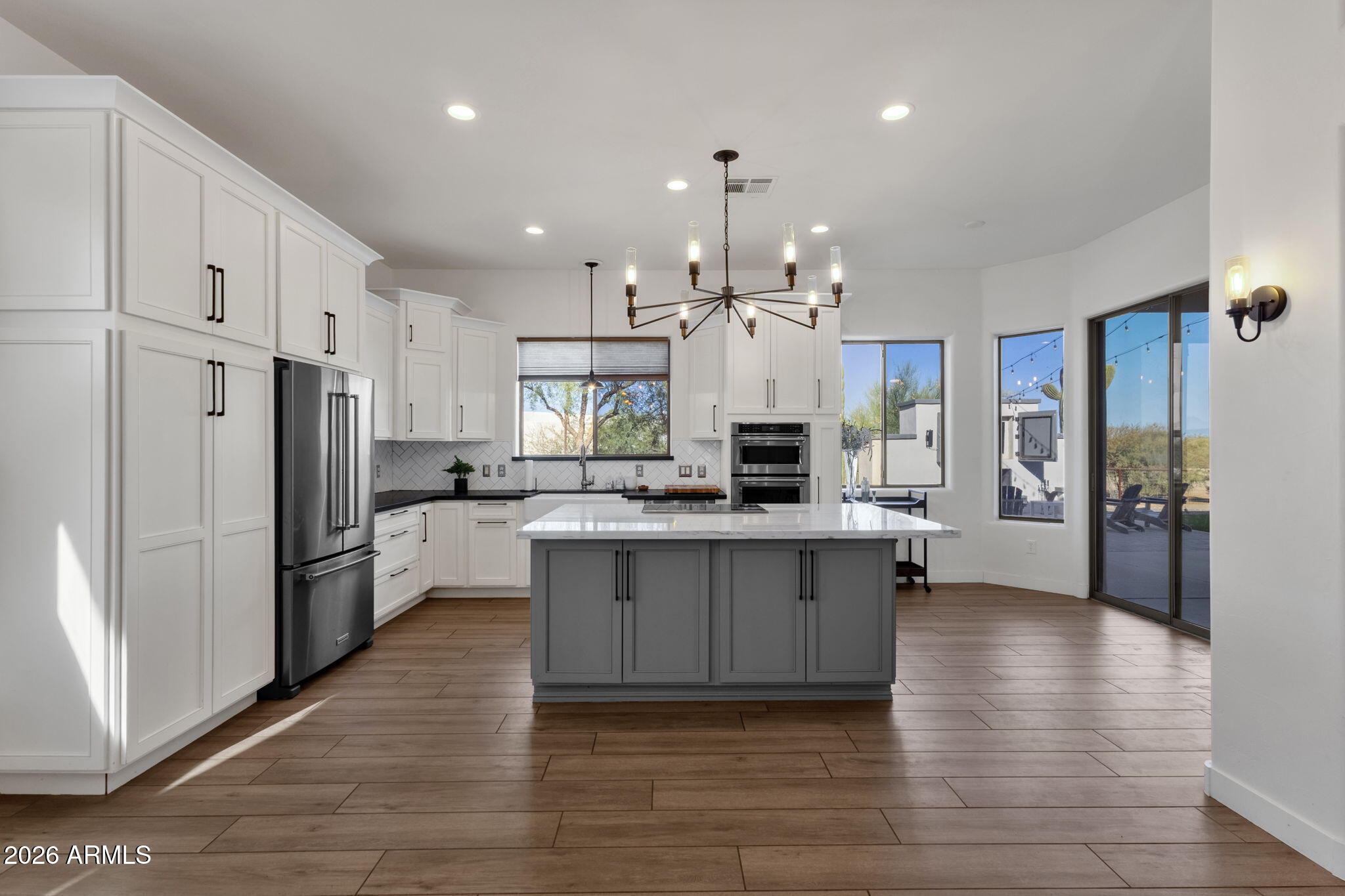 14604 East Peak View Road Scottsdale, AZ 85262 - Photo 11 of 55 a kitchen with stainless steel appliances kitchen island granite countertop a refrigerator and a stove top oven