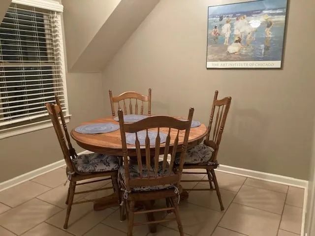 a view of a dining room with furniture and window