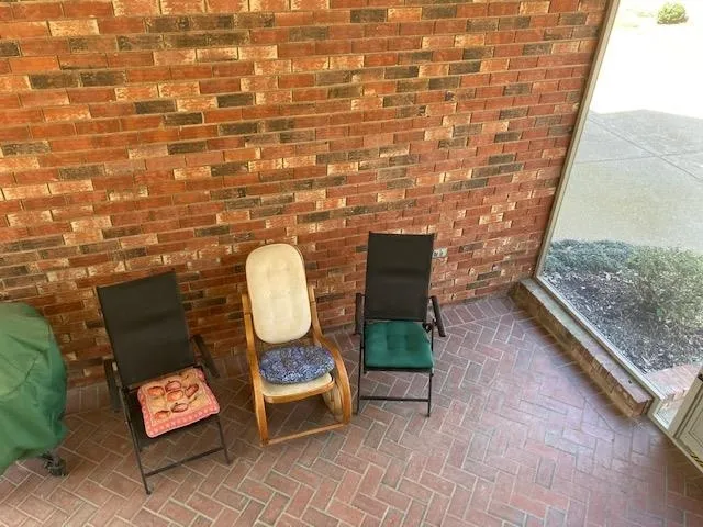 a view of a room with chairs and a table