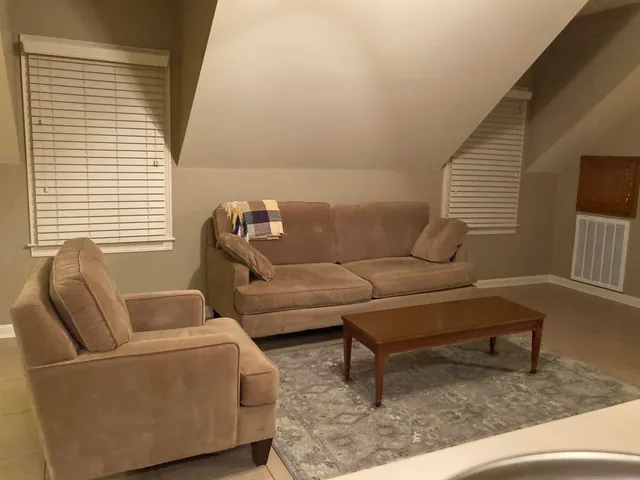a living room with furniture and a window