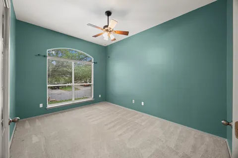 an empty room with windows and outdoor view