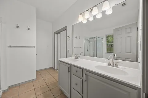 a bathroom with a sink double vanity and a mirror