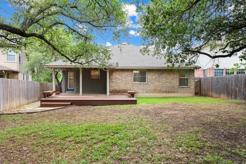 a view of a house with yard and a tree