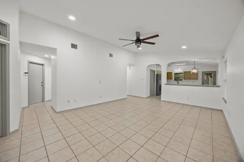 a view of a kitchen with furniture and an empty room