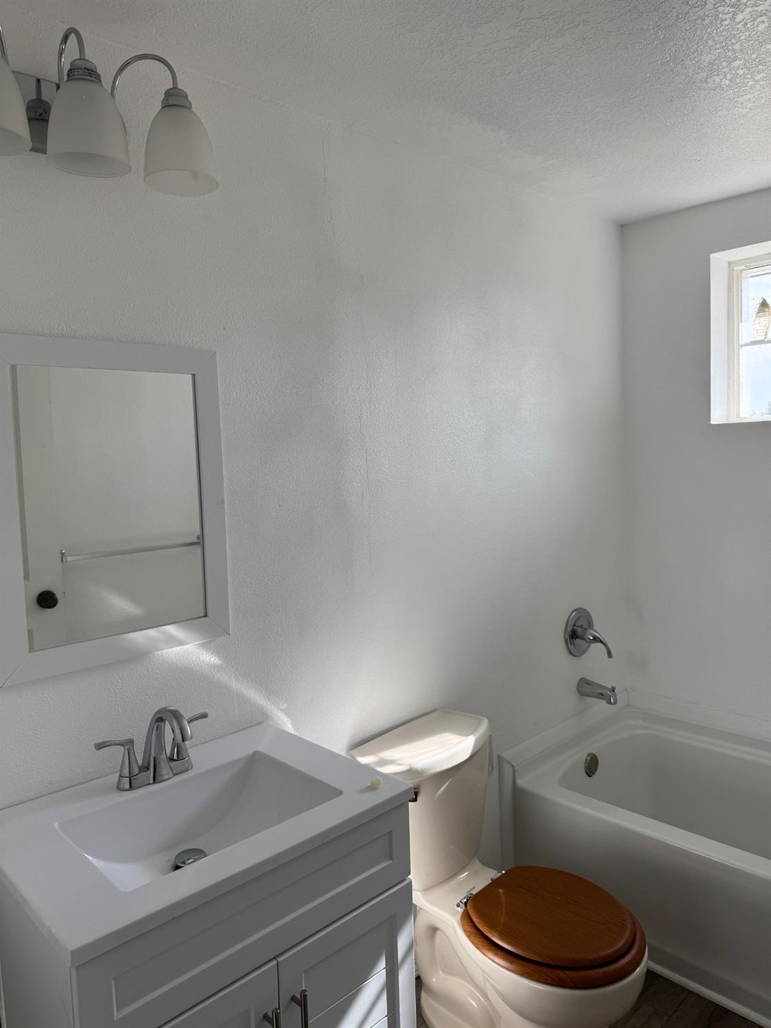 28640 Ward Street Madera, CA 93638 - Photo 17 of 31 a bathroom with a sink a toilet and a mirror