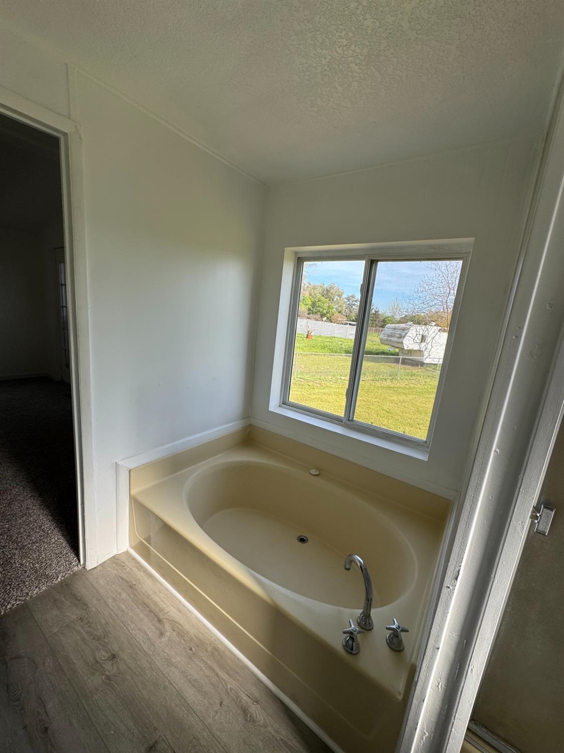 28640 Ward Street Madera, CA 93638 - Photo 24 of 31 a bathroom with a tub and shower