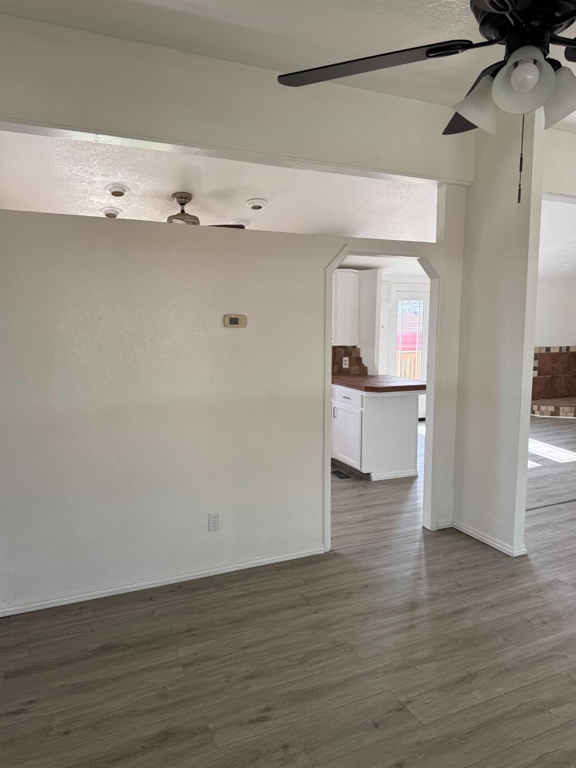 28640 Ward Street Madera, CA 93638 - Photo 8 of 31 a view of a kitchen with wooden floor and cabinets