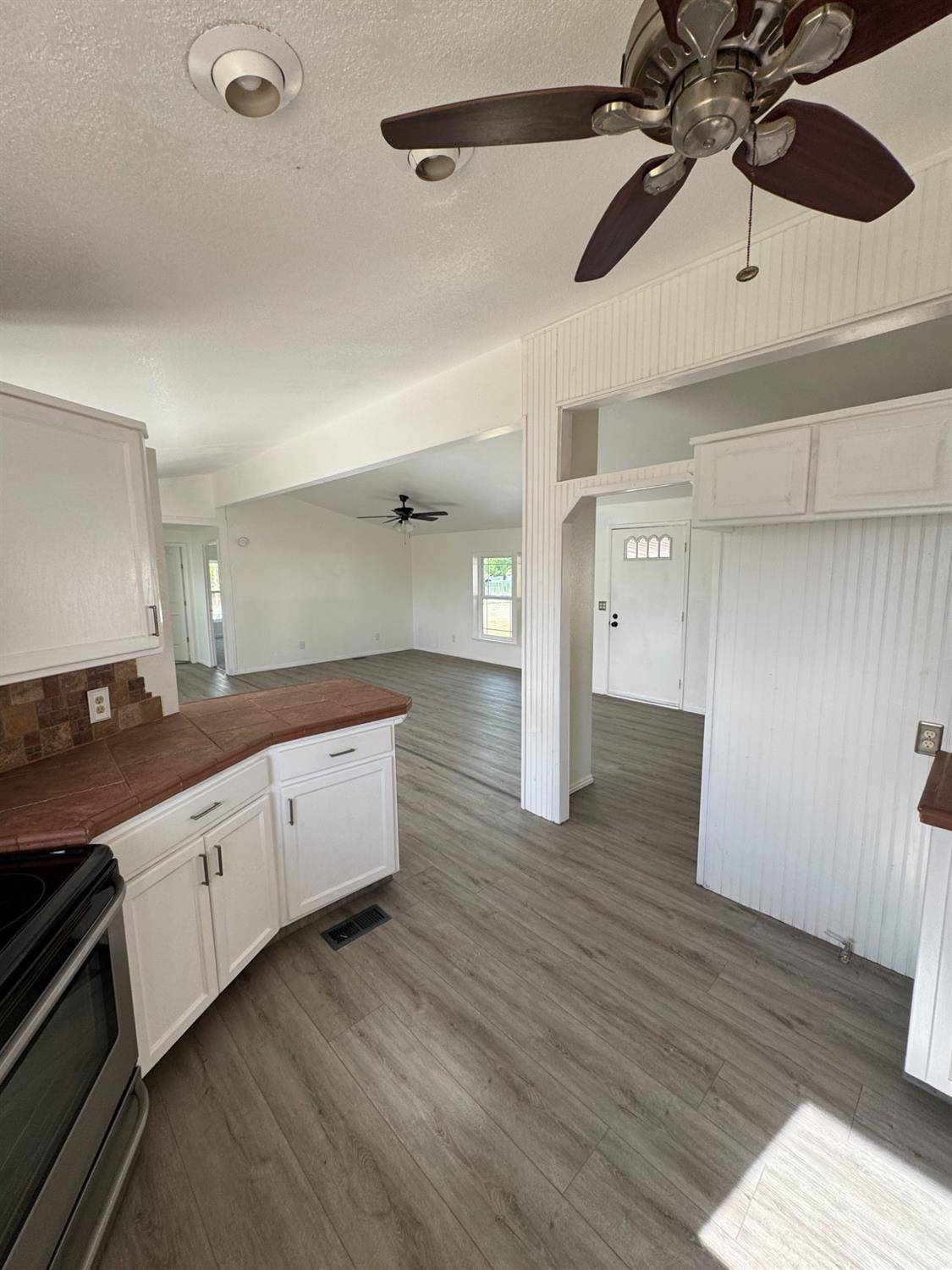 28640 Ward Street Madera, CA 93638 - Photo 10 of 31 a large kitchen with stainless steel appliances a large counter space a sink and a refrigerator