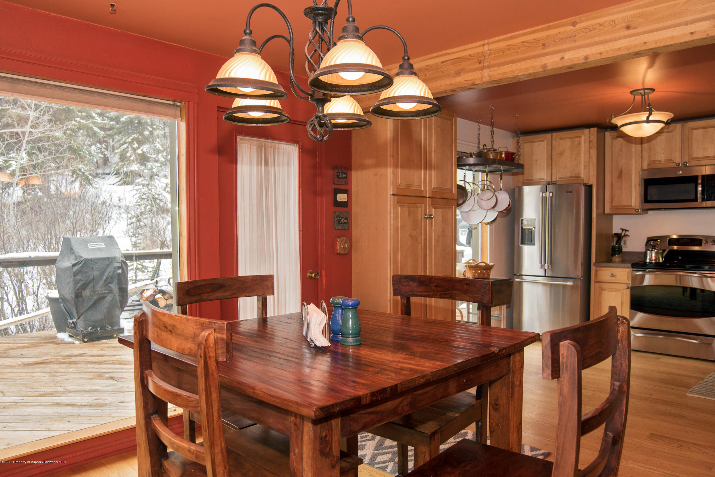 357 Elk Mountain Drive Redstone, CO 81623 - Photo 13 of 40 a dining room with furniture a chandelier and wooden floor