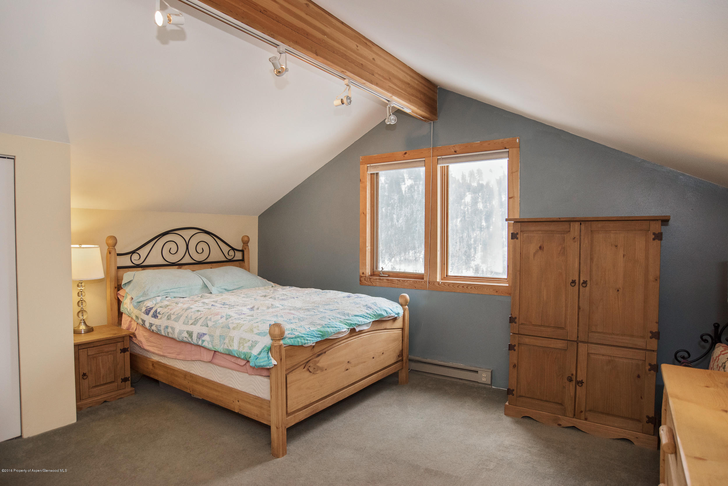 357 Elk Mountain Drive Redstone, CO 81623 - Photo 17 of 40 a bed sitting in a bedroom next to a window