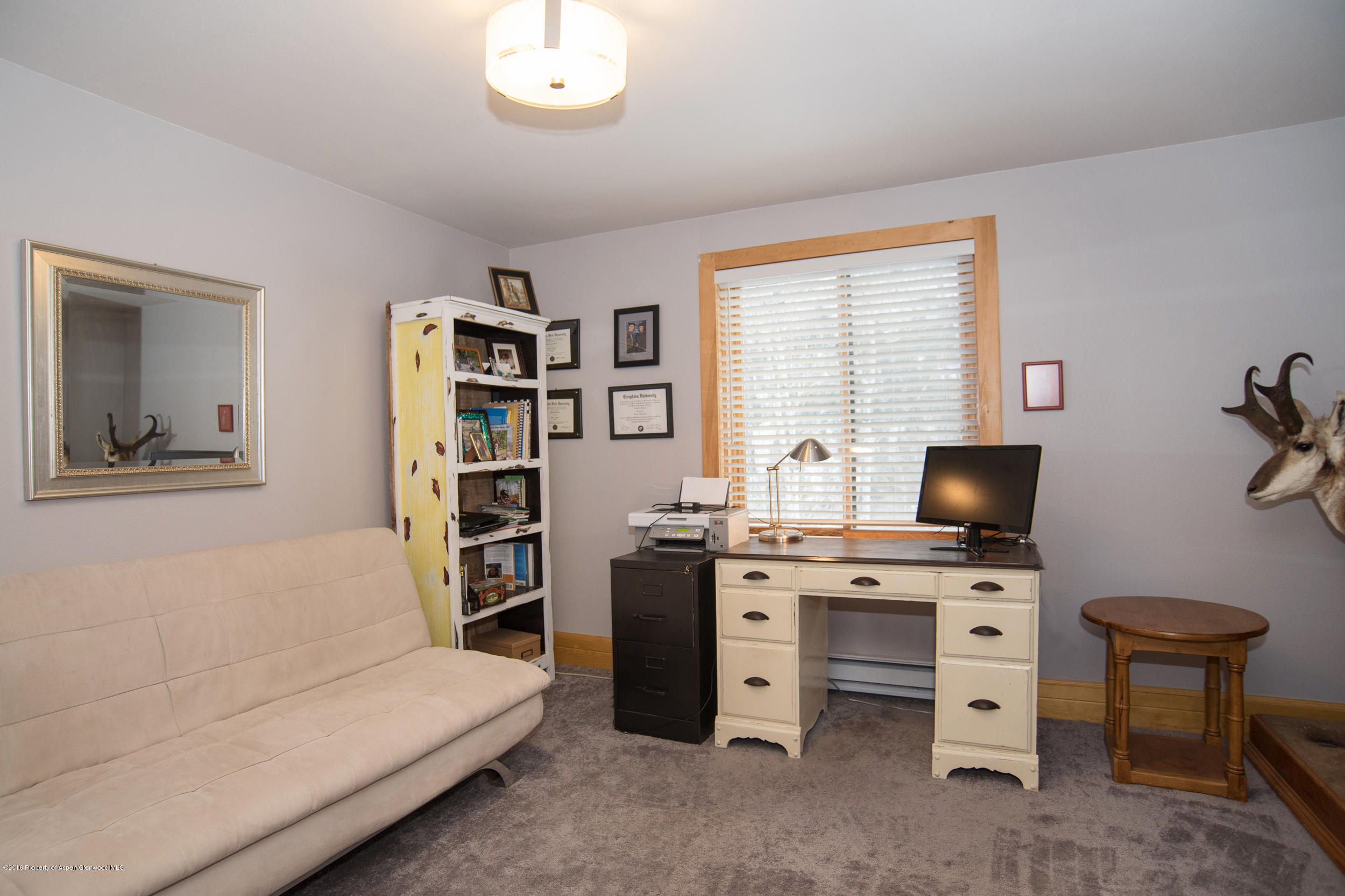 357 Elk Mountain Drive Redstone, CO 81623 - Photo 26 of 40 a livingroom with a big white bed and a desk