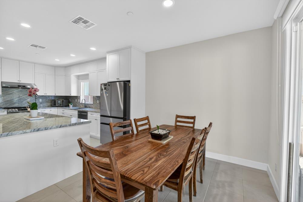 7605 Ferrell Way Elk Grove, CA 95757 - Photo 15 of 69 a dining hall with stainless steel appliances granite countertop a dining table and chairs