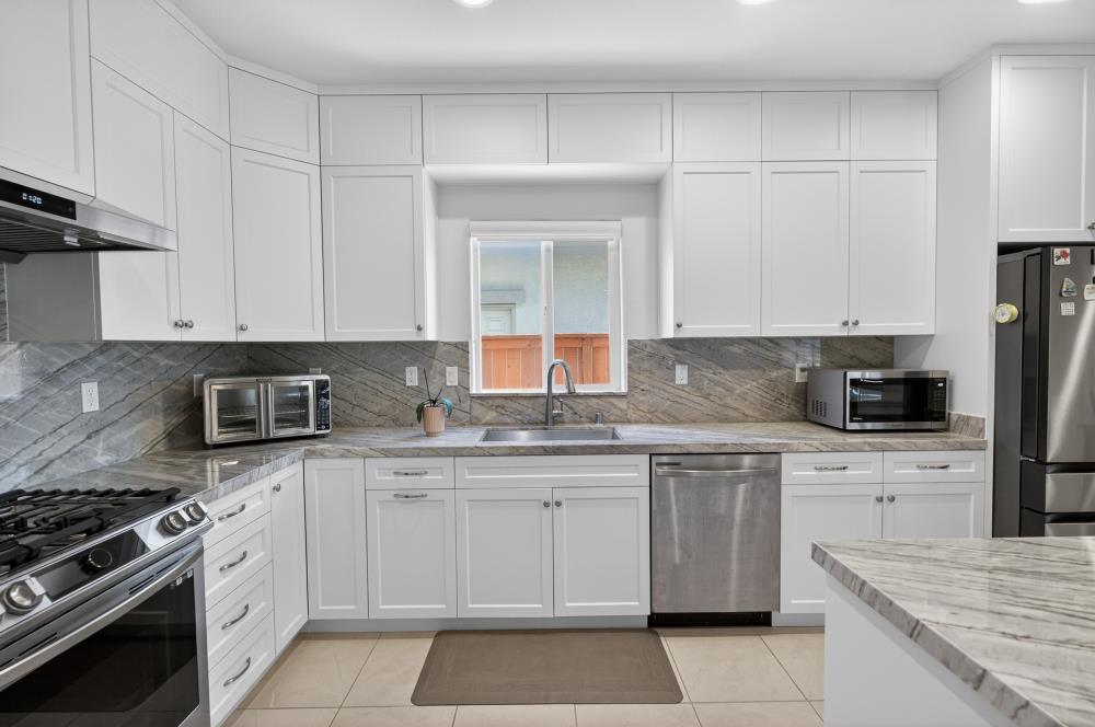 7605 Ferrell Way Elk Grove, CA 95757 - Photo 18 of 69 a kitchen with cabinets appliances a sink and a counter top space