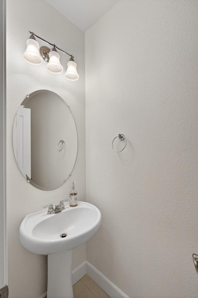 7605 Ferrell Way Elk Grove, CA 95757 - Photo 30 of 69 a bathroom with a sink and mirror