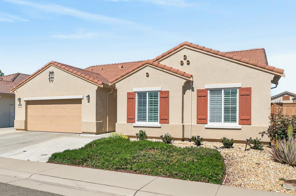 7605 Ferrell Way Elk Grove, CA 95757 - Photo 3 of 69 a front view of a house with a yard and garage