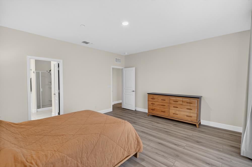 7605 Ferrell Way Elk Grove, CA 95757 - Photo 33 of 69 a bedroom with a bed and a painting on the wall