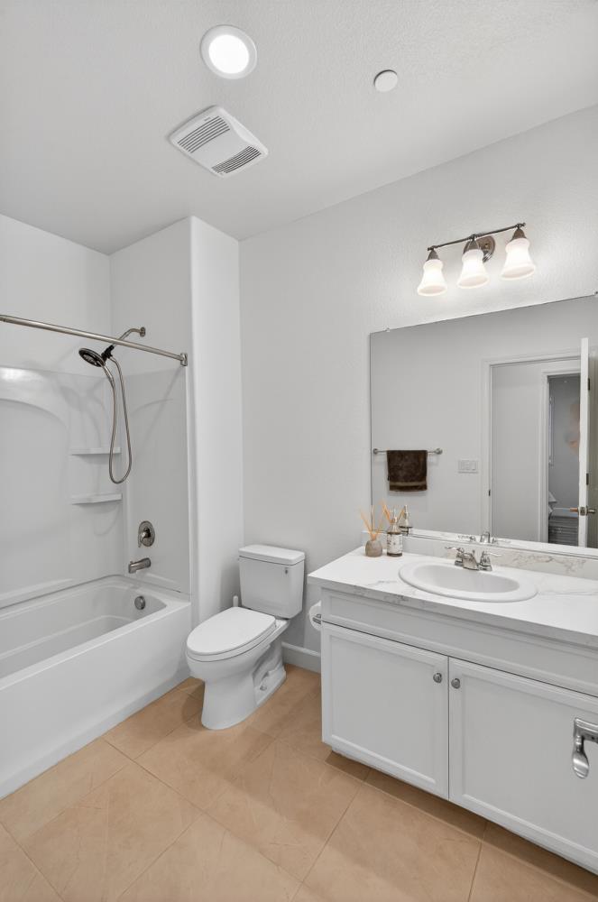7605 Ferrell Way Elk Grove, CA 95757 - Photo 49 of 69 a bathroom with a double vanity sink toilet mirror and shower