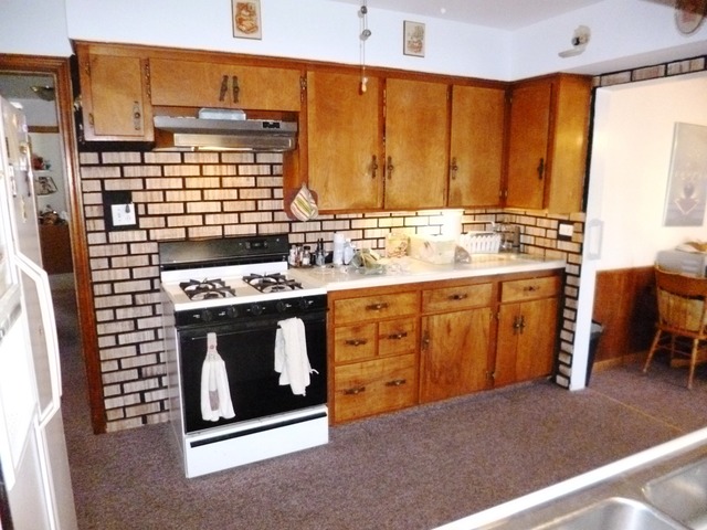 1802 Evergreen Road Homewood, IL 60430 - Photo 4 of 23 a kitchen with a stove sink and cabinets