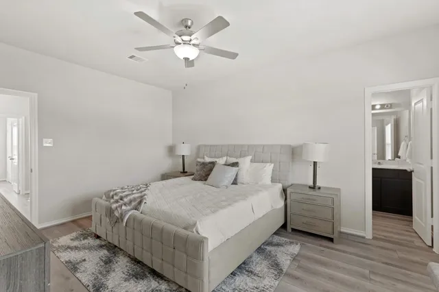 a bedroom with a large bed and a window