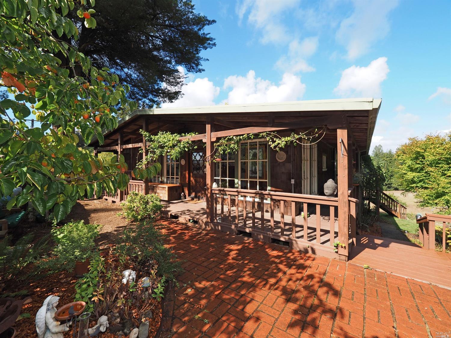 a view of a house with a yard balcony and sitting area