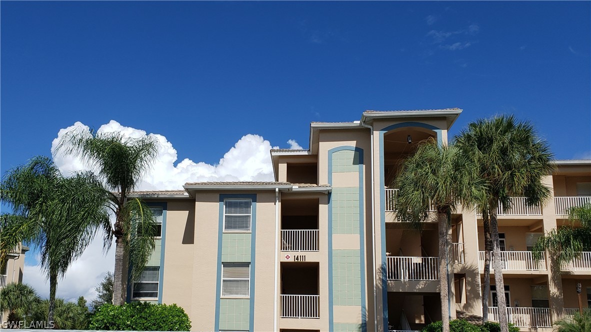 14111 Brant Point Circle, Unit 2201 Fort Myers, FL 33919 - Photo 1 of 30 a view of a house with a potted plant and floor to ceiling window
