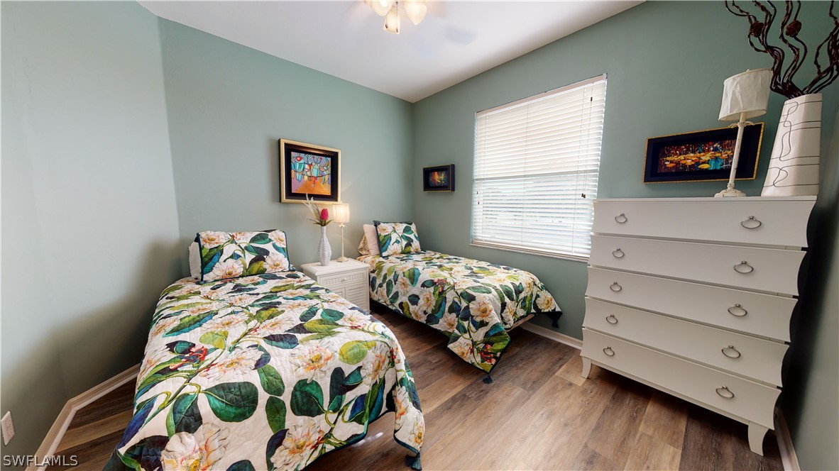 14111 Brant Point Circle, Unit 2201 Fort Myers, FL 33919 - Photo 11 of 30 a bedroom with two beds and a tv