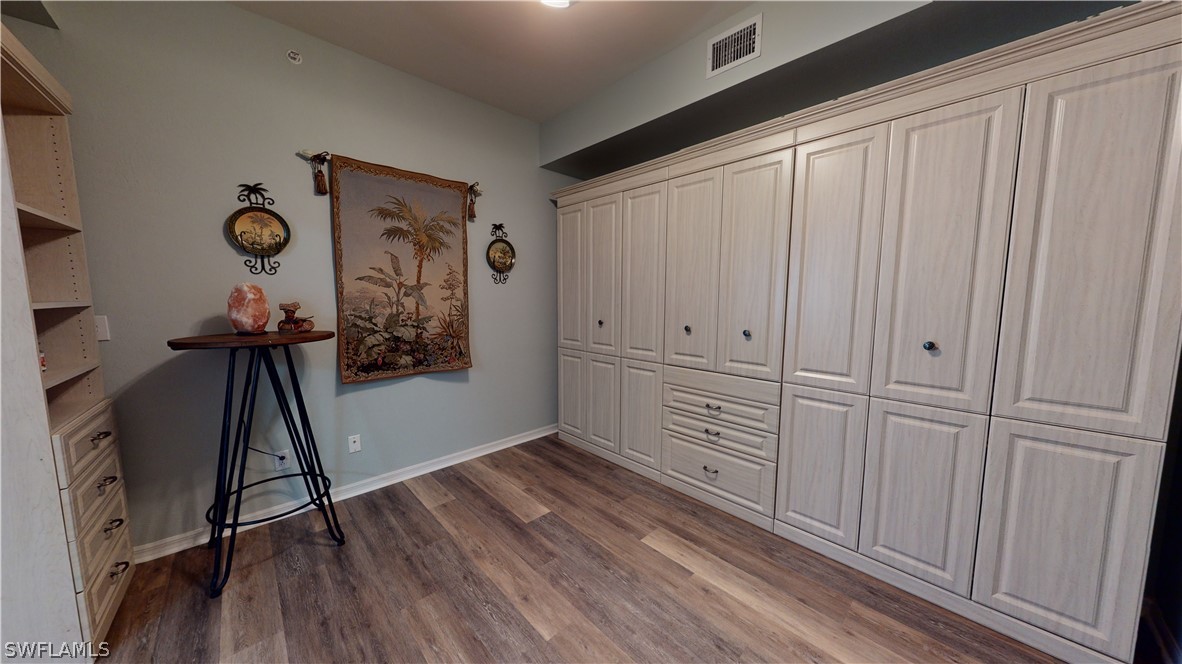14111 Brant Point Circle, Unit 2201 Fort Myers, FL 33919 - Photo 14 of 30 a view of a hallway with wooden floor