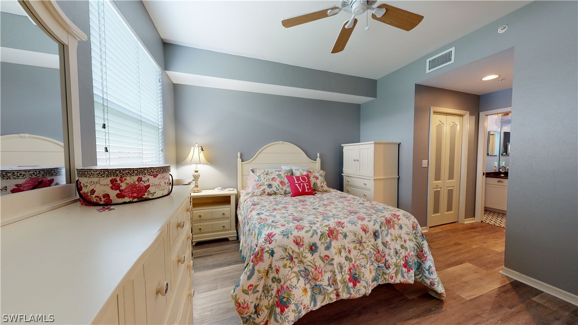 14111 Brant Point Circle, Unit 2201 Fort Myers, FL 33919 - Photo 16 of 30 a bedroom with a bed and a dresser
