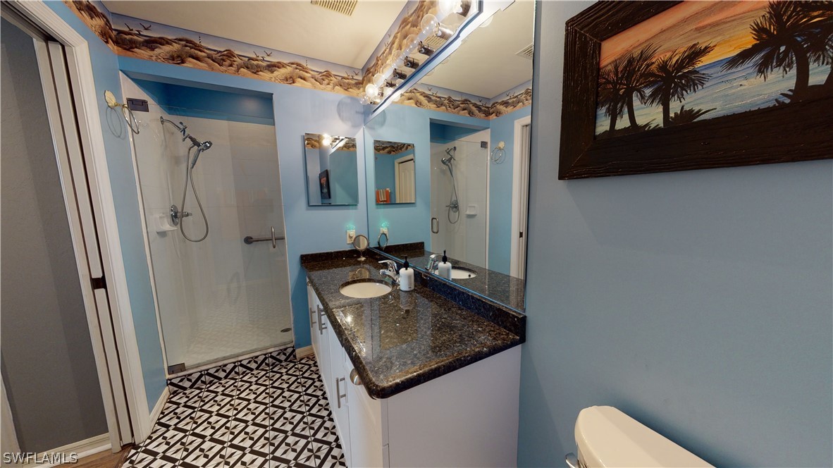 14111 Brant Point Circle, Unit 2201 Fort Myers, FL 33919 - Photo 17 of 30 a bathroom with a sink a toilet and shower