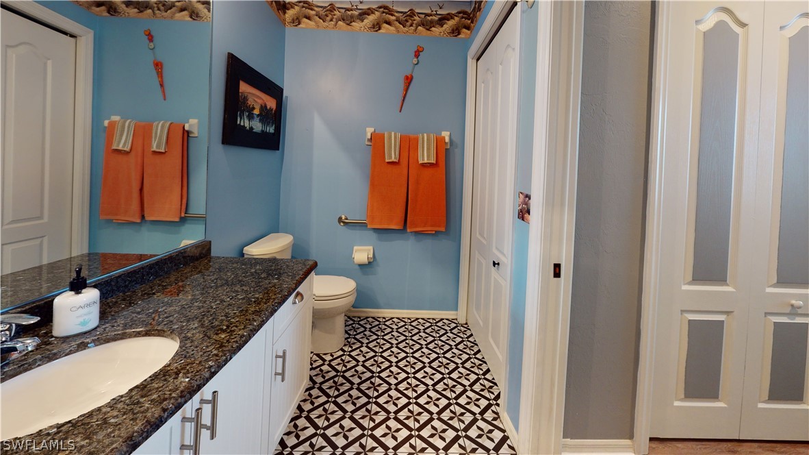 14111 Brant Point Circle, Unit 2201 Fort Myers, FL 33919 - Photo 18 of 30 a bathroom with a granite countertop sink and a mirror