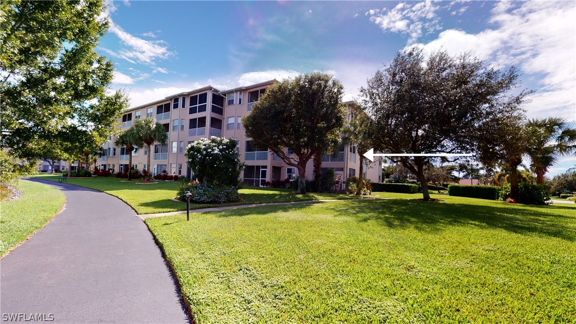 14111 Brant Point Circle, Unit 2201 Fort Myers, FL 33919 - Photo 20 of 30 a front view of a building with trees