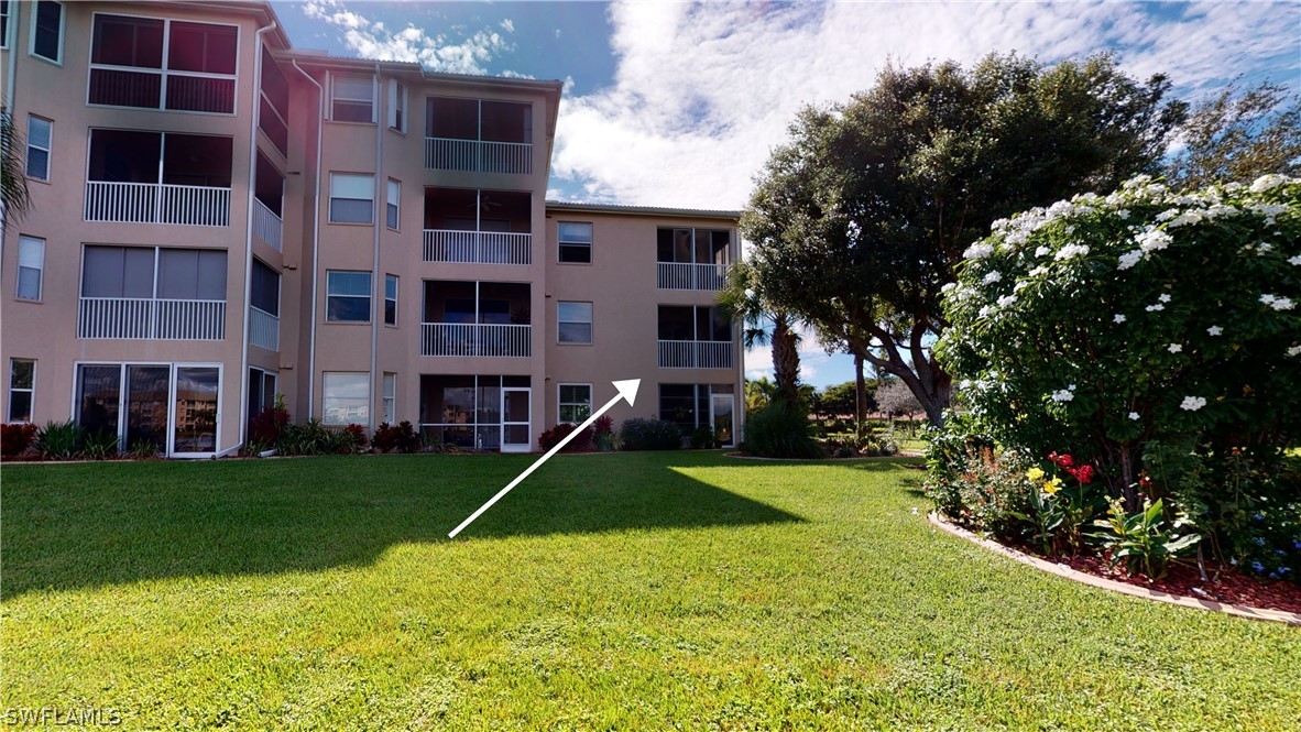 14111 Brant Point Circle, Unit 2201 Fort Myers, FL 33919 - Photo 21 of 30 a view of a house with swimming pool and a yard