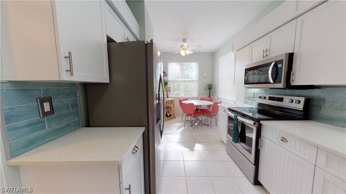 14111 Brant Point Circle, Unit 2201 Fort Myers, FL 33919 - Photo 8 of 30 a kitchen with a refrigerator stove and sink