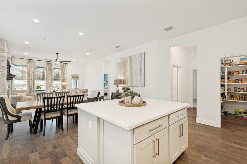 229 Savannah Lane Oak Point, TX 75068 - Photo 11 of 26 a kitchen with a dining table chairs and white appliances