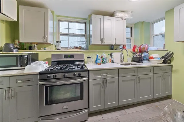 a kitchen with cabinets appliances and a sink