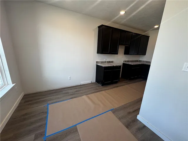 a kitchen with stainless steel appliances a sink stove and microwave