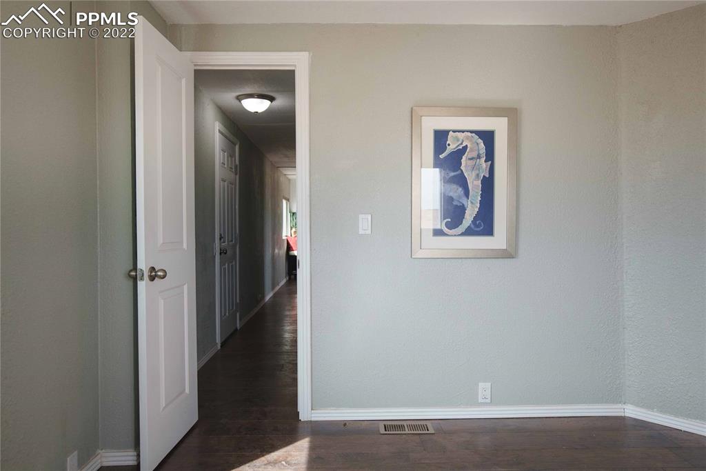 6605 Lauppe Road Yoder, CO 80864 - Photo 12 of 38 an empty room with closet and mirror