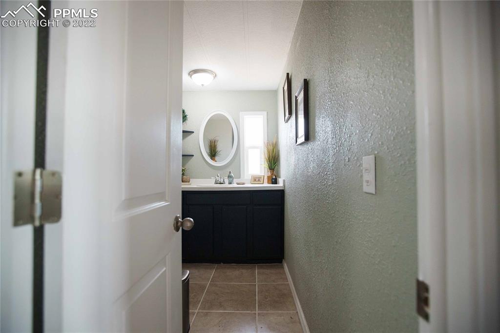 6605 Lauppe Road Yoder, CO 80864 - Photo 14 of 38 a bathroom with a sink and a mirror