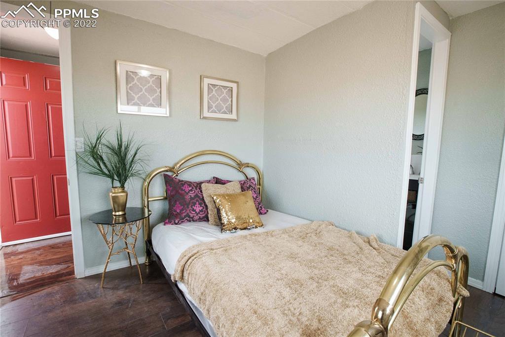 6605 Lauppe Road Yoder, CO 80864 - Photo 15 of 38 a bedroom with a bed and a potted plant